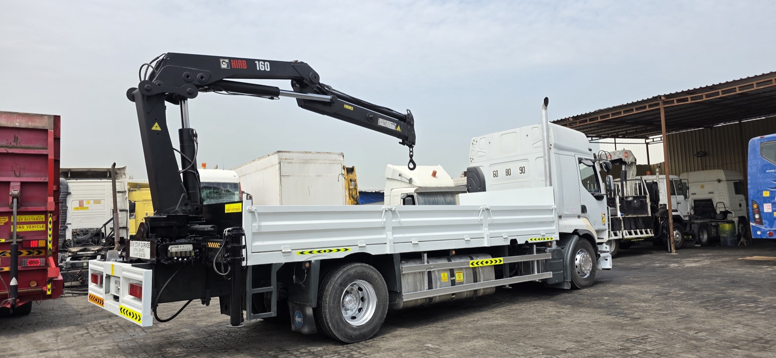 Articulated heavy Hiab knuckle-boom truck delivering in Dubai