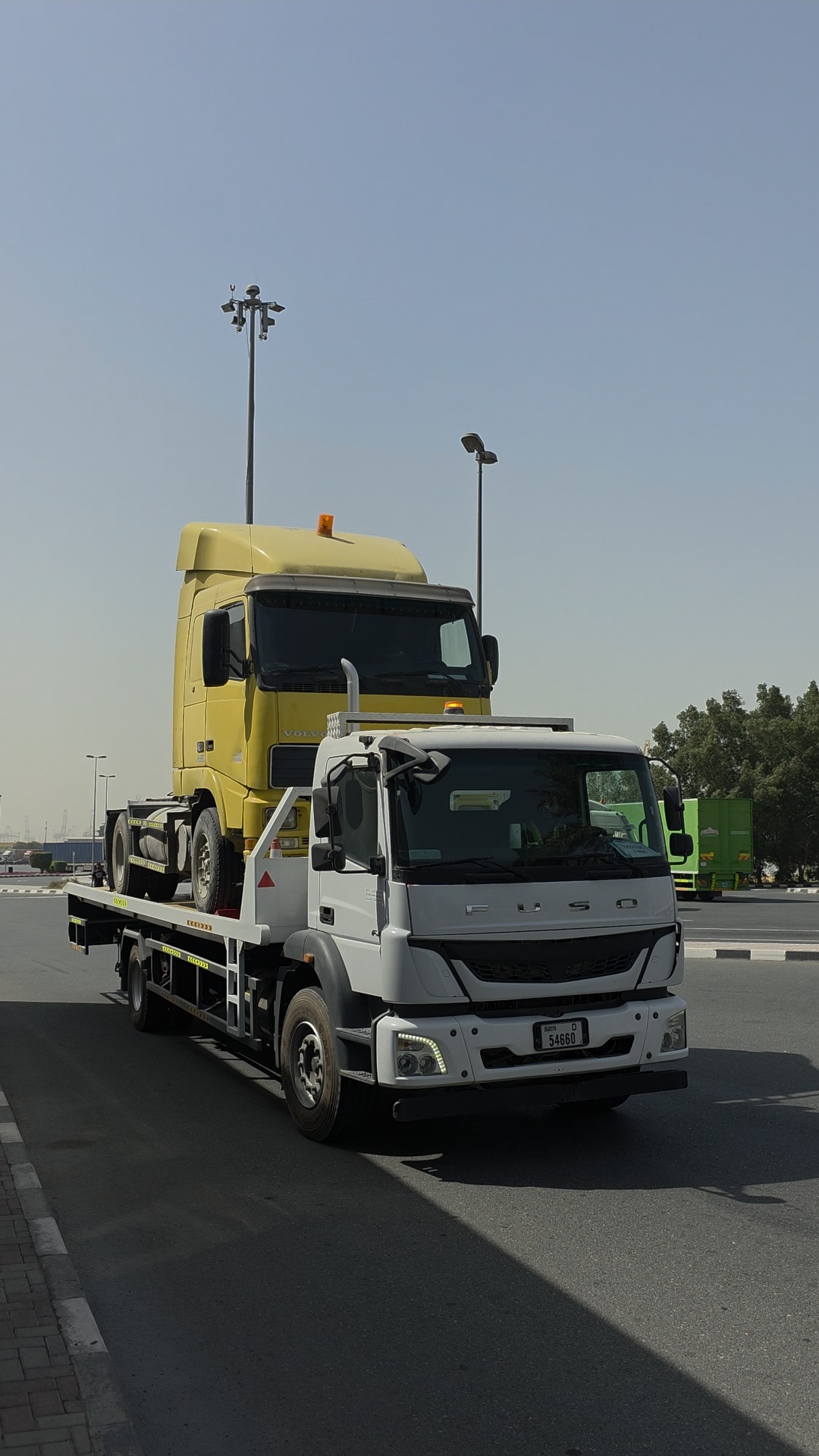 Emergency recovery carrier transporting commercial vehicle in UAE